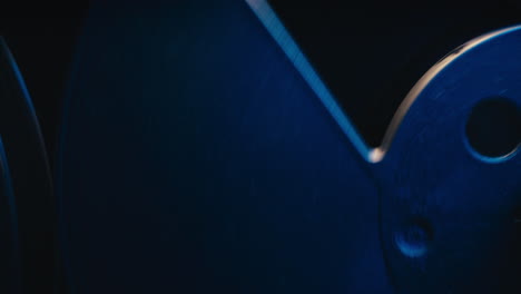 a vintage tape recorder spinning spools in a blue light