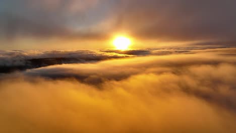 sunset over the clouds, beautiful aerial view of rolling clouds and orange sun