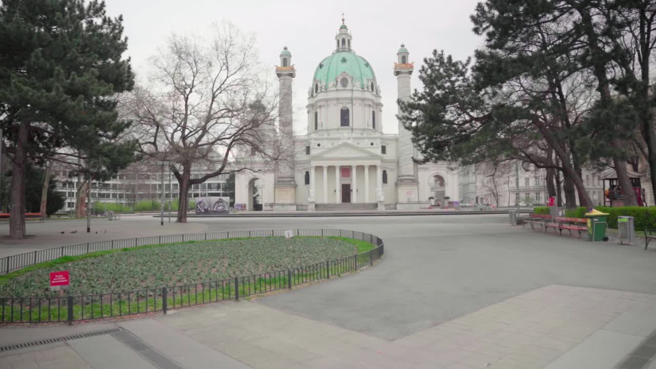 Tilt up walk of empty Karlsplatz and church in Vienna due to pandemic