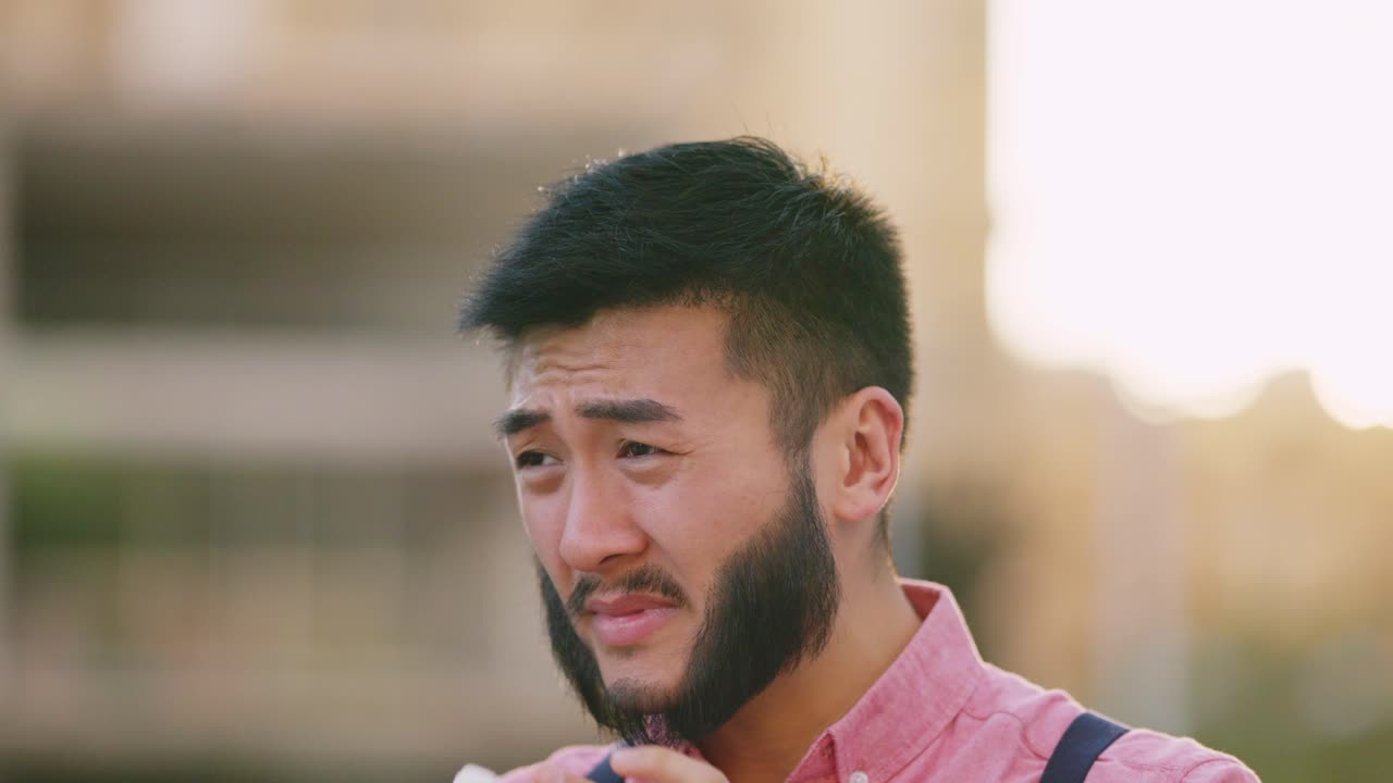 Man sneezing into a tissue