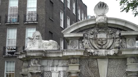 ornamental gate with sculptures and coat of arms