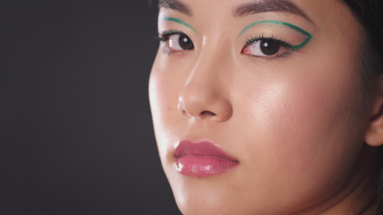 Close-up portrait of a woman with artistic makeup