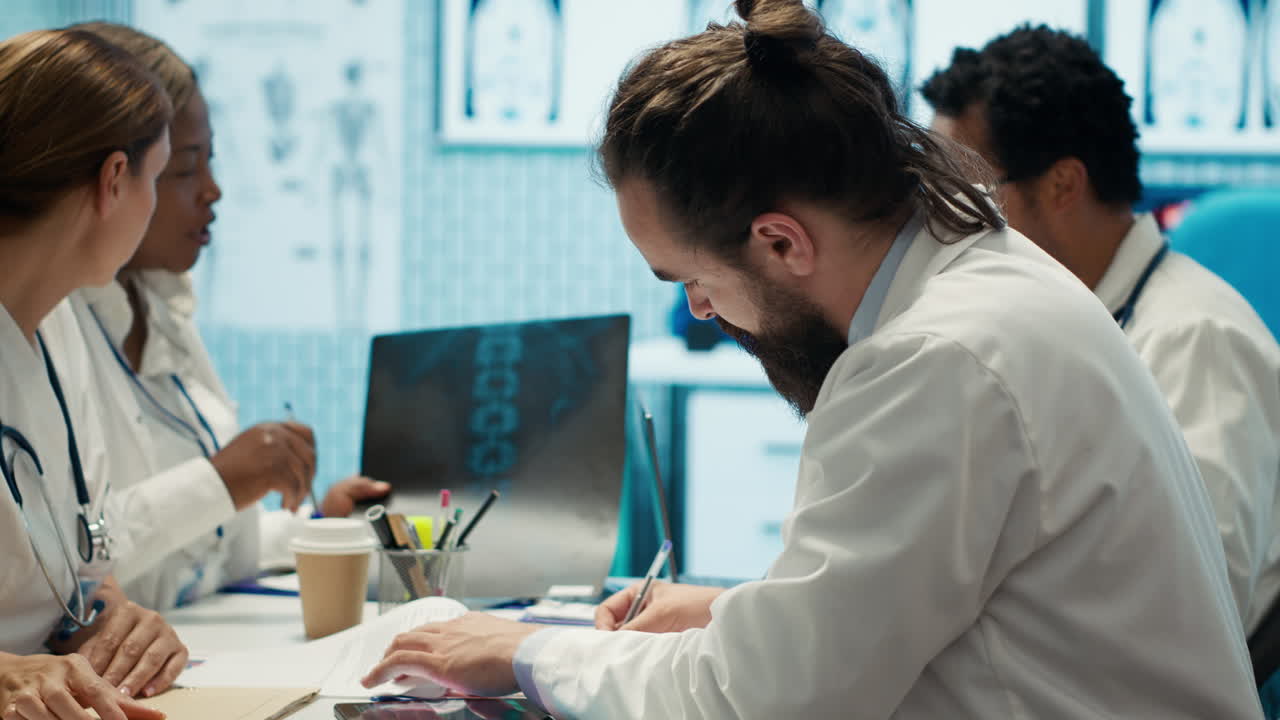 Medical professionals collaborating and analyzing x-rays in an office