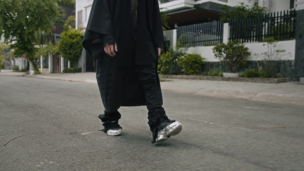 Stylish Caucasian Gen Z Male Model in Black Clothes Walking along Street