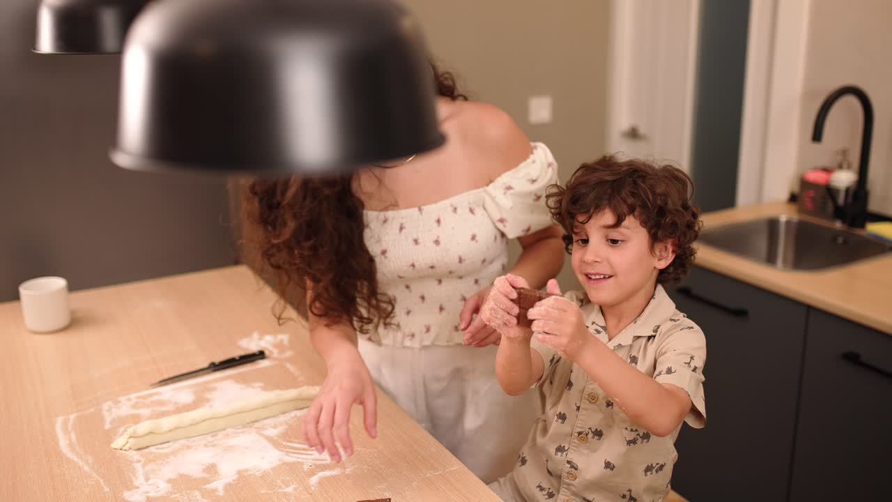 Mother and son baking together in the kitchen