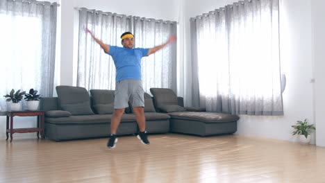 man doing jumping jacks at home