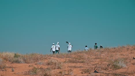 people planting trees in sharjah's desert as part of the uae's 'plant the emirates' initiative