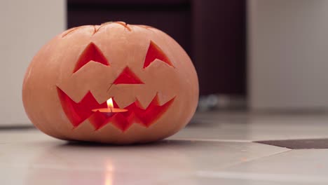 close up of jack o lantern lit from within by candle