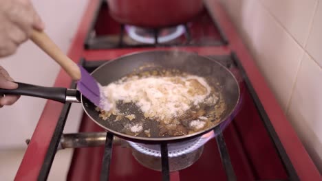 Crop-woman-melting-ingredients-for-dessert-on-pan