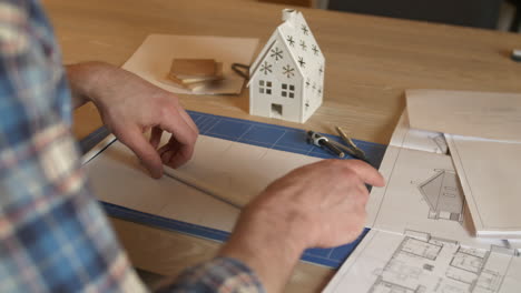 arquitecto dibujando planos con decoración navideña en la mesa