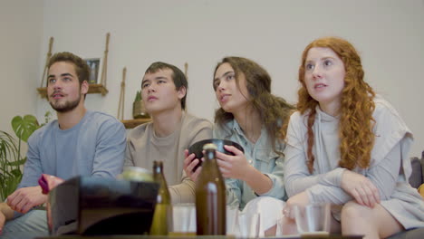 sports fan watching tv and celebrating football teams victory