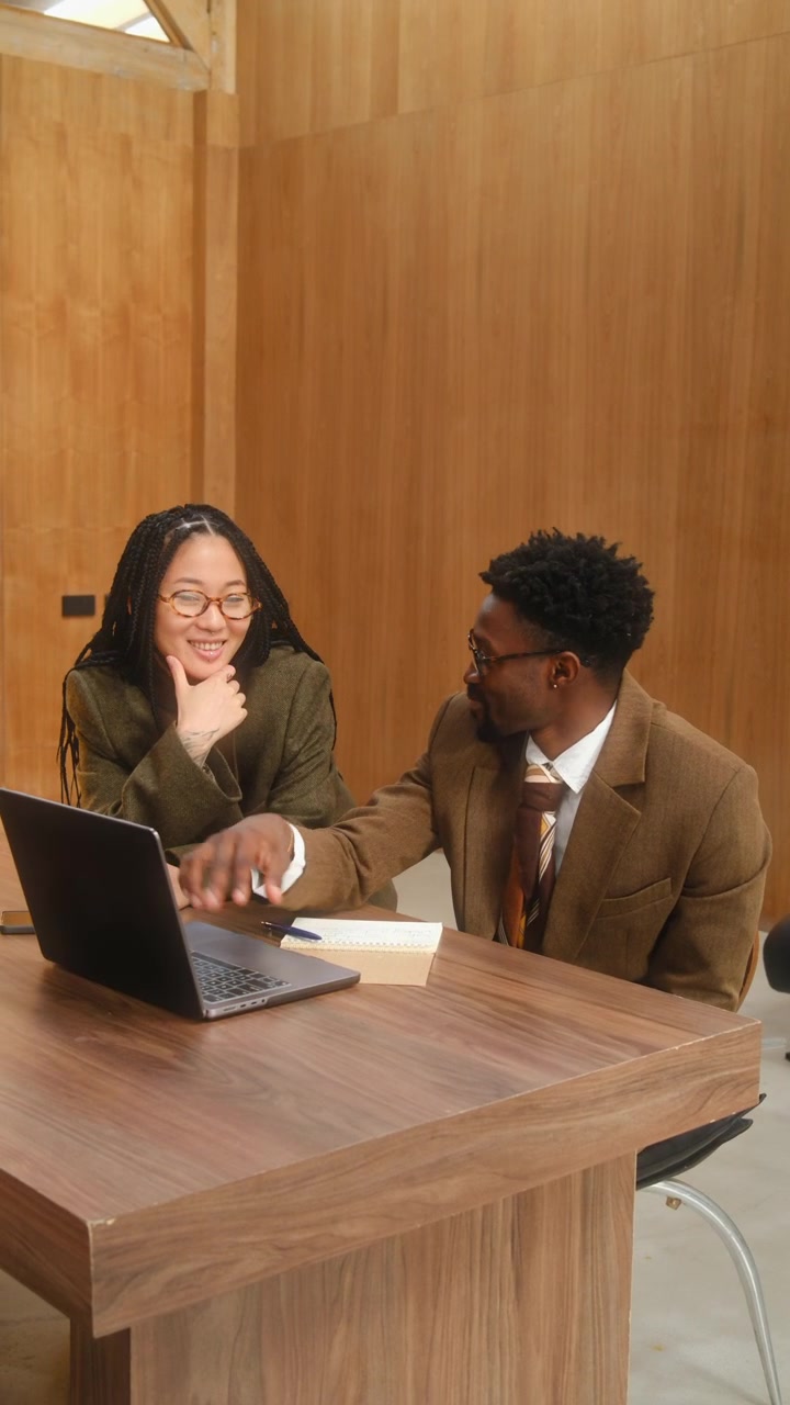 Multiracial Colleagues Discussing Business Data on Laptop in Office