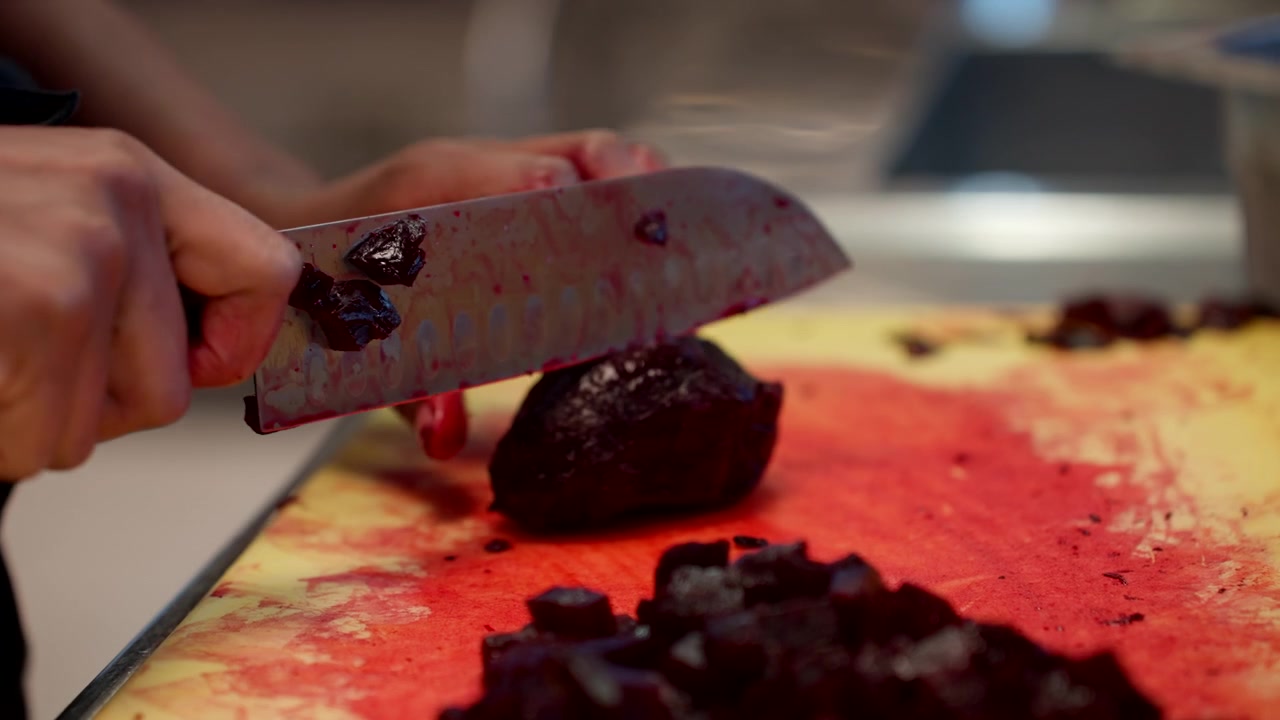 Chef Slicing Baked Beetroot In Diced On The Chopping Board. - closeup shot