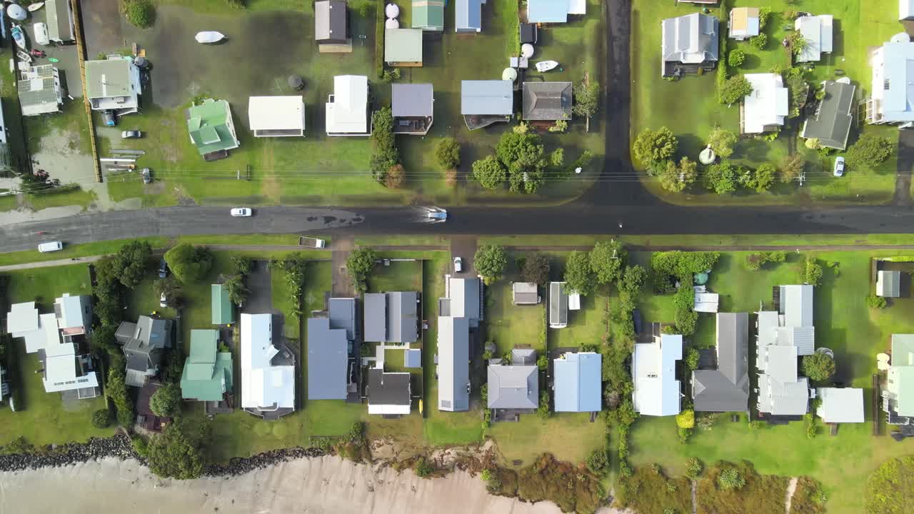 Aerial view of cars driving through flood waters after Cyclone Gabrielle in New Zealand