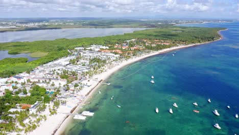 Aerial-drone-wide-panoramic-view-of-Laguna-Bavaro-Wildlife-Refuge-with-boats-and-coastline-In-Punta-Cana,-Dominican-Republic