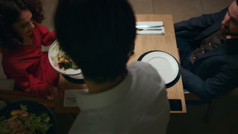 waiter serving italian dinner to couple in restaurant. lovers enjoy evening.