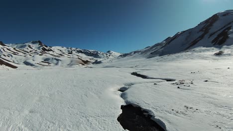 FPV-drone-soaring-through-the-heart-of-the-Andes,-capturing-the-stunning-landscapes-of-Paso-Pehuenche