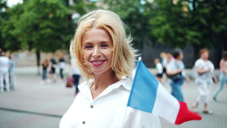 woman holding french flag in city