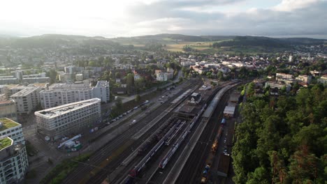 aerial view of a train station in a city surrounded by green spaces
