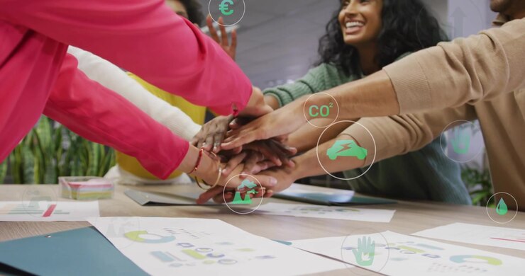 Team members reviewing charts stacking hands for business goals, animated green icons above papers