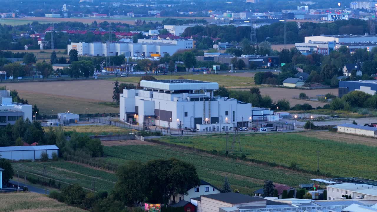 Aerial view of a modern data center in Warsaw, Poland, showing a secure server facility and communication hub within an industrial and suburban land