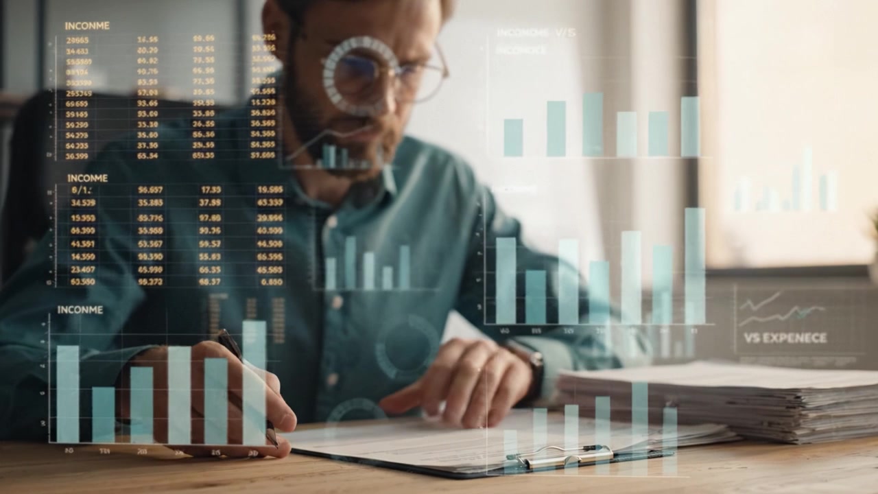 Focused Professional Analyzing Data Trends with Financial Graphs while Taking Notes in Office Setting, Illustrating Detailed Analytical Processes in Work Environment