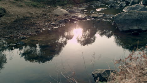 water moving through the rocks in a river and being touched by the wind