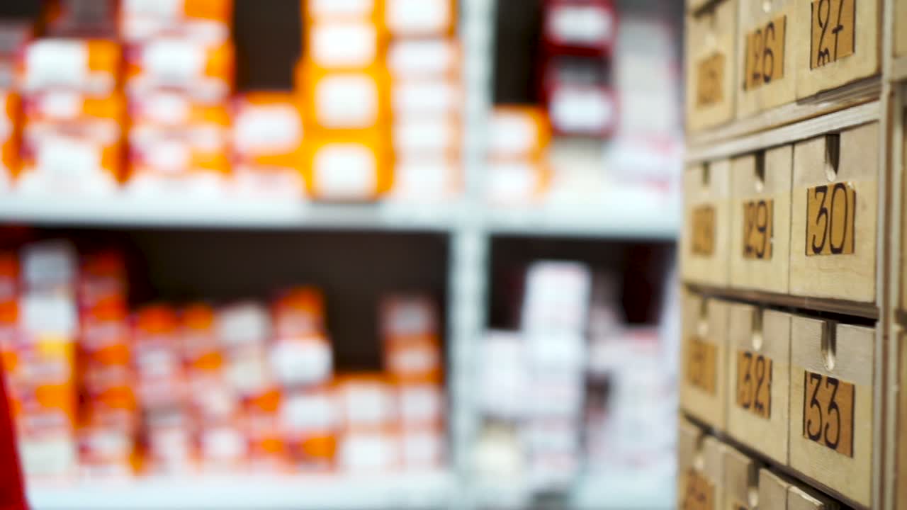 Warehouse worker organizing parts in a storage cabinet