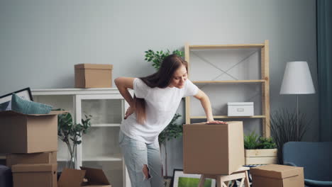 woman struggling with moving boxes