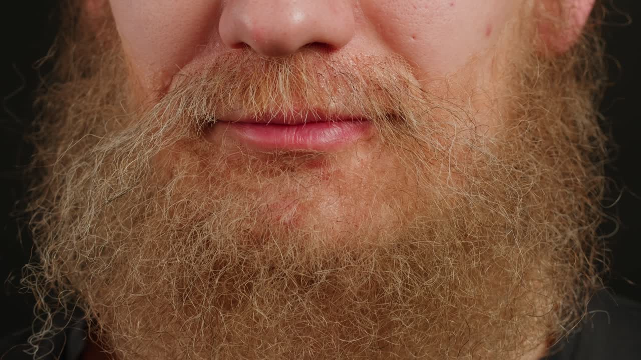 Make up artist making Disheveled blond beard for a man in theater, actors sfx cinema make up, close-up. Mens fashion, halloween style. making old guy.