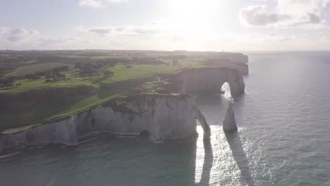 aerial drone shot of etretat along the seaside cliffs in normandy at northern france