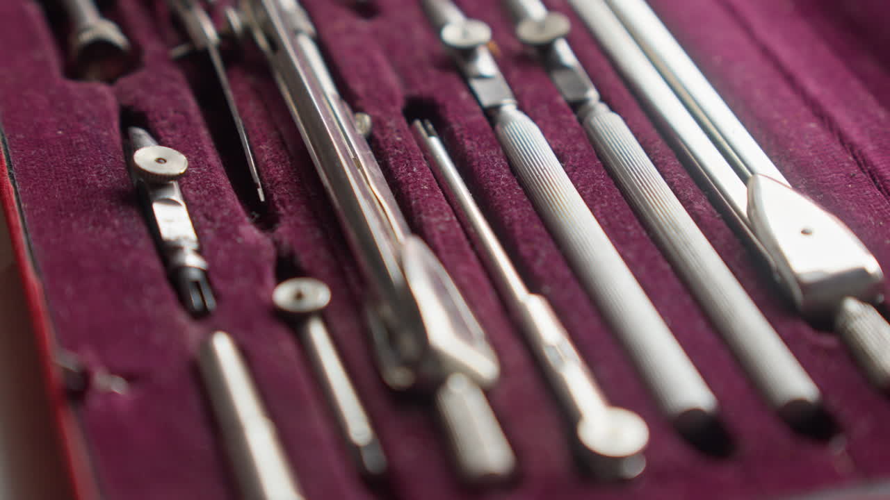Cinematic pull focus across a neatly arranged drafting tool set, highlighting order, craftsmanship, and professional design environment