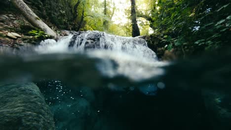 split-level shot, 50 50, half half video of small waterfall and the under water