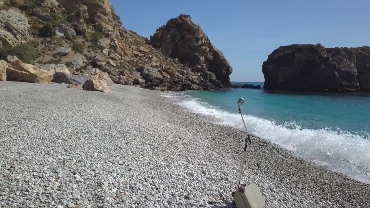 Travelling towards a vintage microphone in the beach on a sunny day