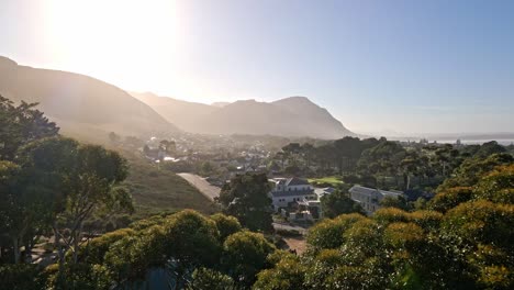 a scene of mountains and trees at sunrise in hermanus south africa