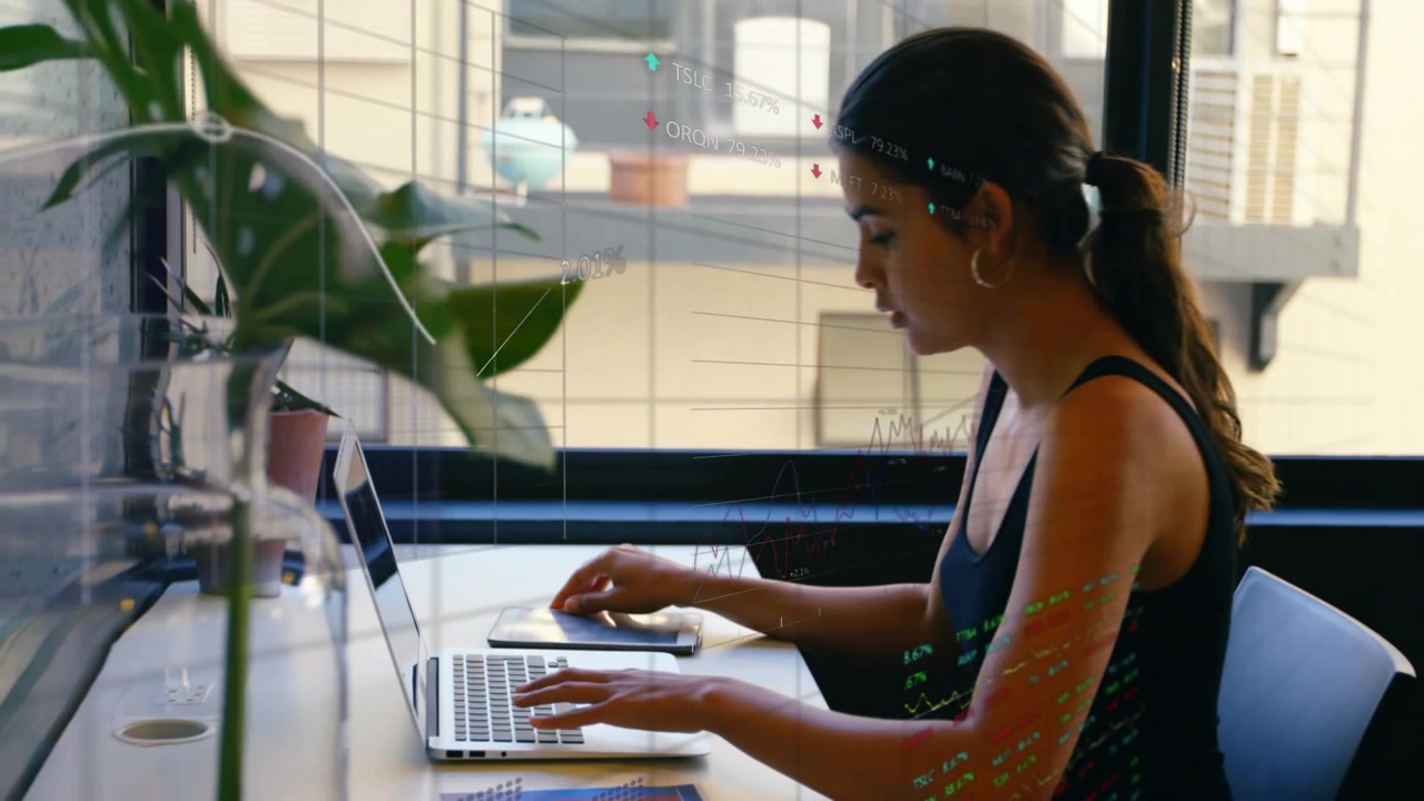 Vertical video: Holding phone woman in black putting tablet by laptop typing viewing data at cafe