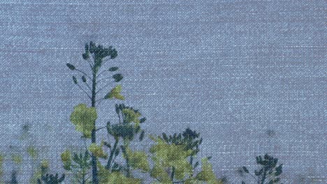 animation of denim over moving flowers and grass