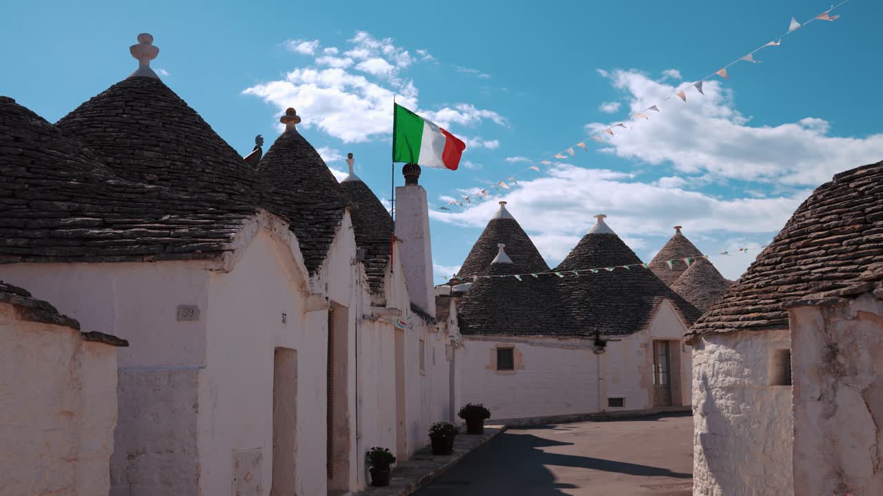 Trulli in Alberobello, Italy with Italian Flag