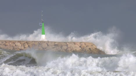 stormy waves crashing onto harbor sea wall, slow motion