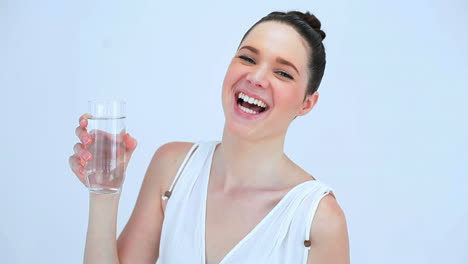 smiling woman drinking a glass of water