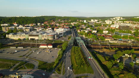 Aerial-View-Of-Truss-Bridge-Over-Multilane-Railroad-Of-Trains-and-Complicated-Roads-Intersection-In-Gdansk,-Poland,-slow-back-flight