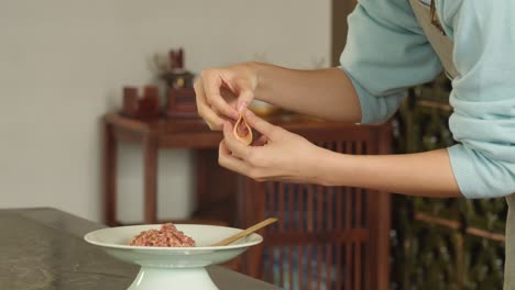 Woman-making-gyoza