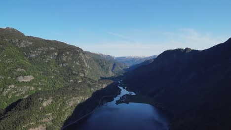 descending drone capturing a picturesque view of a mountainous landscape during the summer