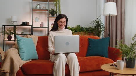amazed woman use laptop computer receive good news message shocked by victory celebrate win