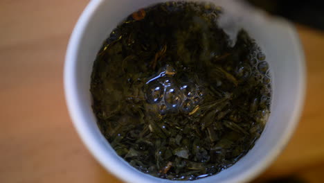 Closeup-Of-Pouring-Boiling-Water-Into-A-Cup-Of-Green-Tea,-Healthy-Drink-Beverage-From-Asia