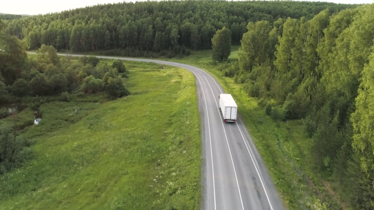 Truck on a Winding Country Road through Forest