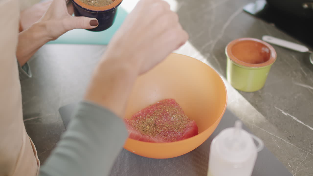 Adding Spices To Tuna Steak In Bowl
