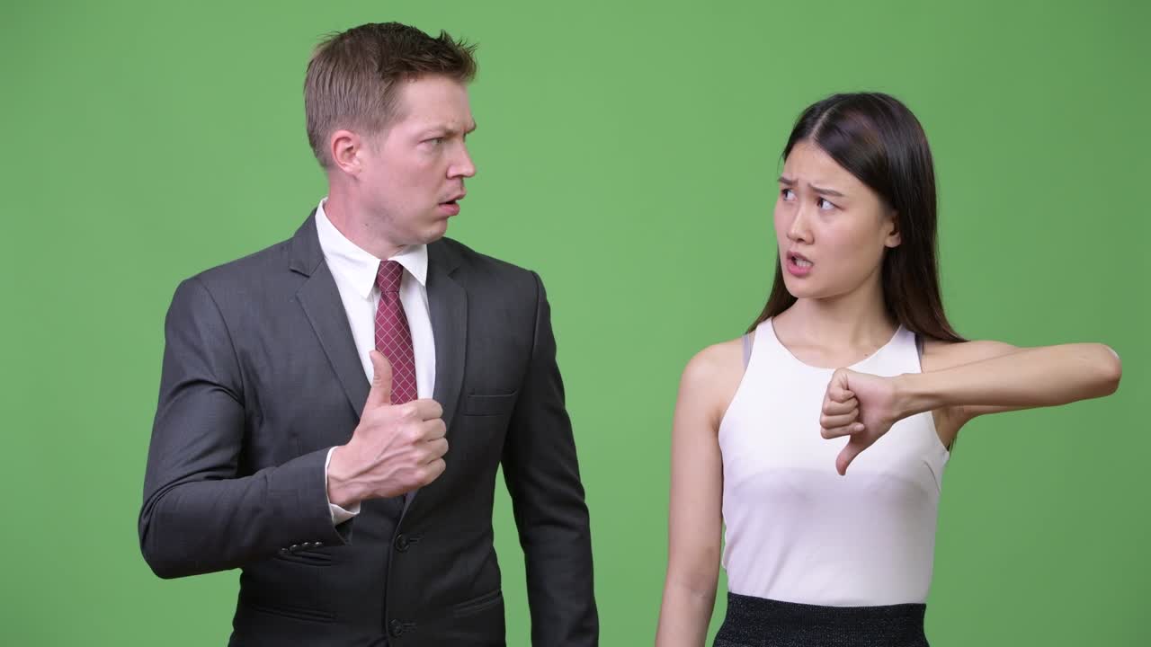 Multi-ethnic business couple having different decisions