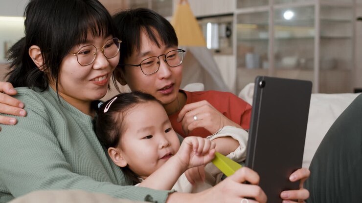Family watching tablet together