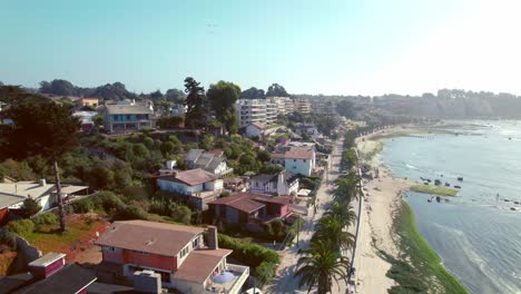 Luftaufnahme-In-Zeitlupe-Von-Apartments-Direkt-Am-Meer-Mit-Blick-Auf-Den-Strand-Von-Pejerrey-In-Algarrobo